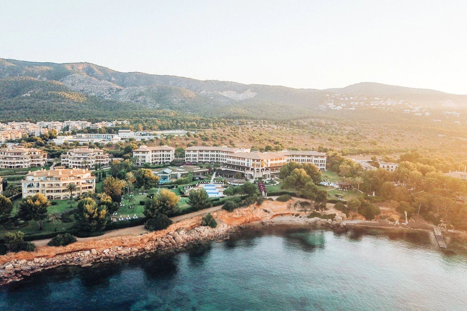 Aerial view of a coastal resort hotel at sunset